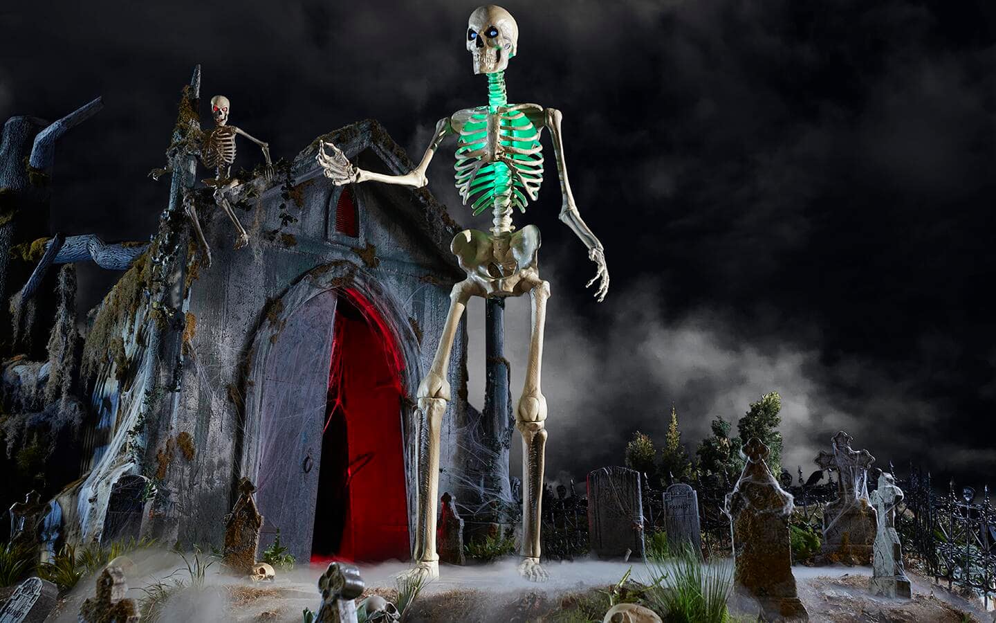 A 12-foot skeleton in a graveyard featuring a green, LED glow-in-the-dark chest.