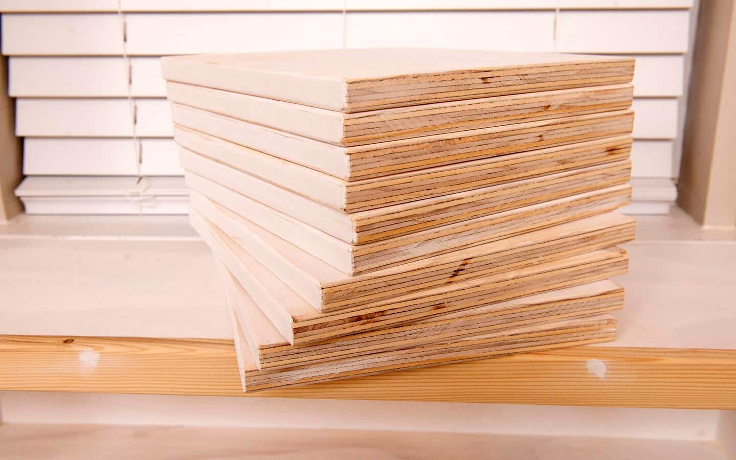 A stack of movable dividers, showing the edges that are sanded smooth but purposely left unpainted.