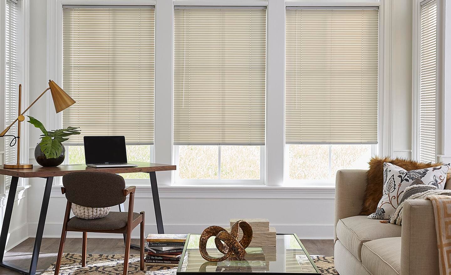 Vinyl blinds cover the windows in a small living area.