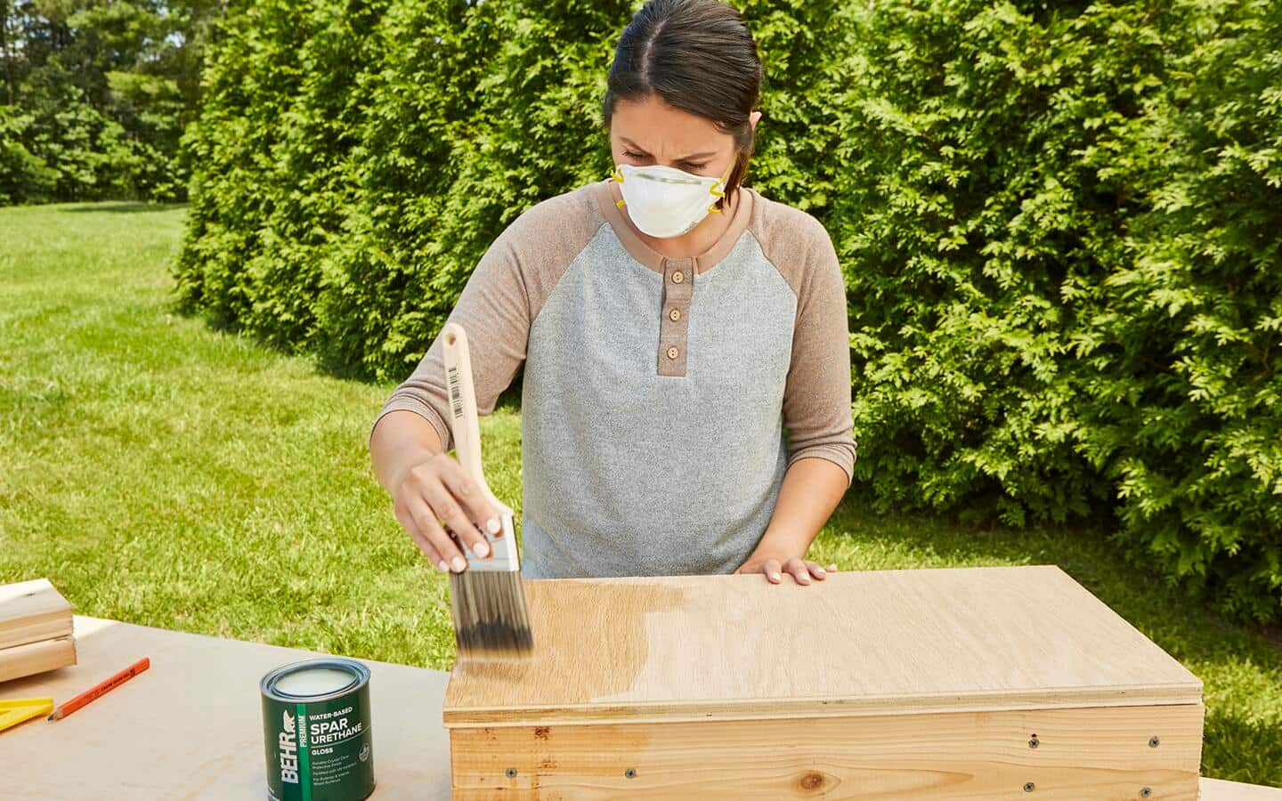 A person applies polyurethane with a brush to the root cellar. A person applies polyurethane with a brush to the root cellar.