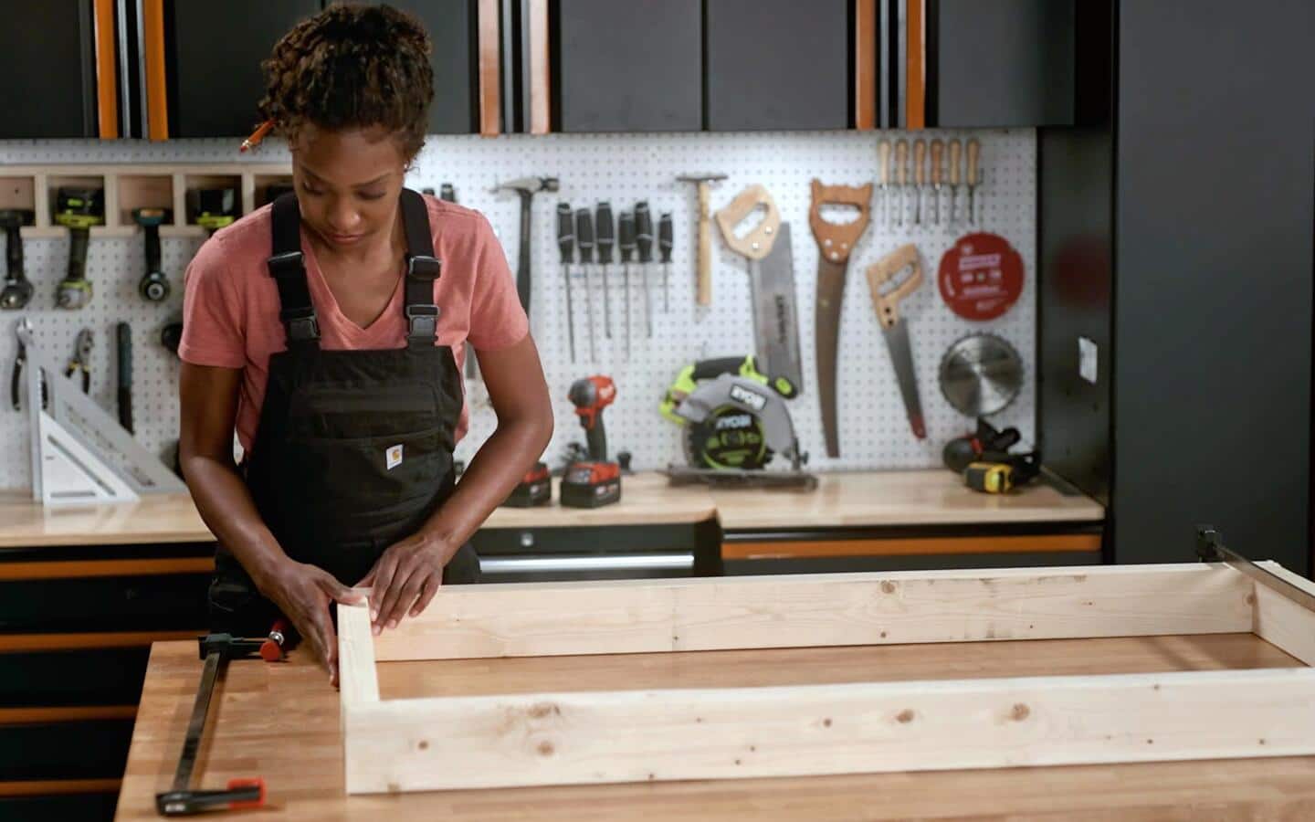 Someone assembling the base of a cornhole board. Someone assembling the base of a cornhole board.