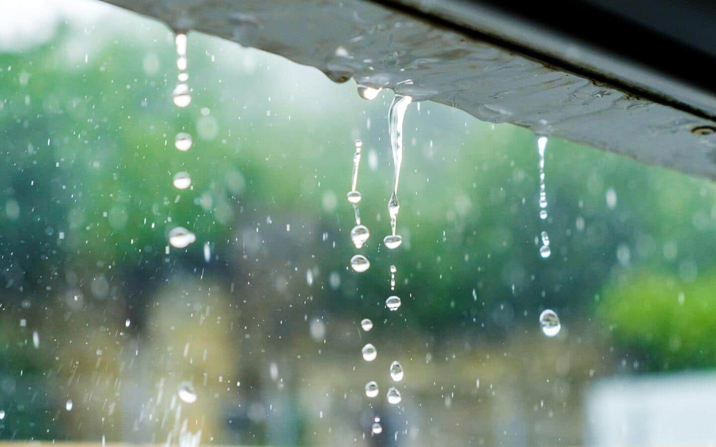 Rain dripping off the gutter on a roof.