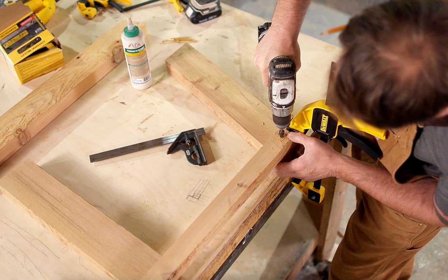 A person attaching the arm support to the legs of an Adirondack chair. A person attaching the arm support to the legs of an Adirondack chair.