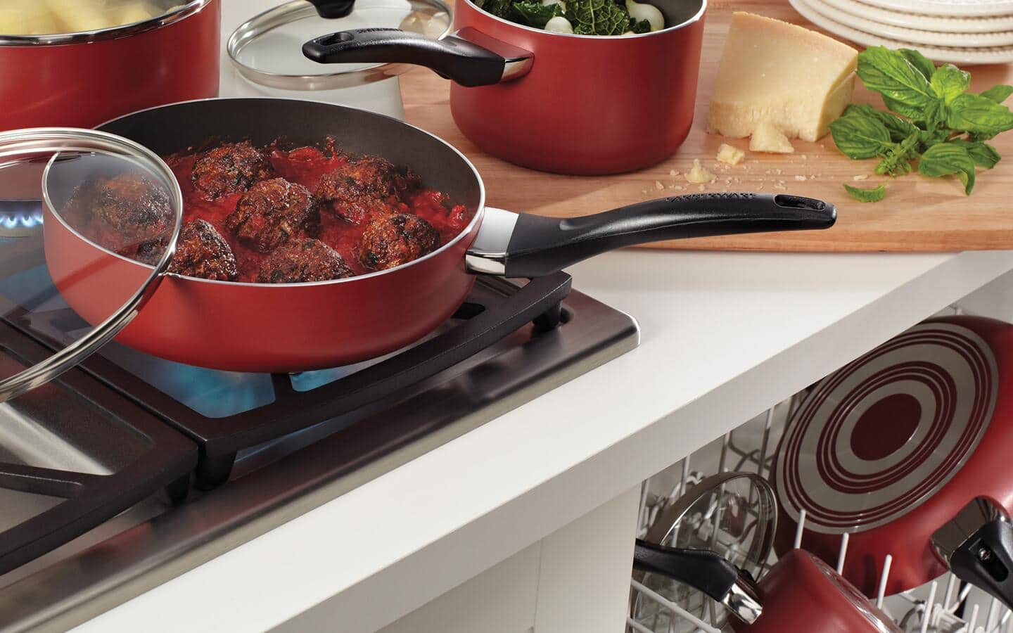 Dishwasher-safe cookware being used to make spaghetti and meatballs.