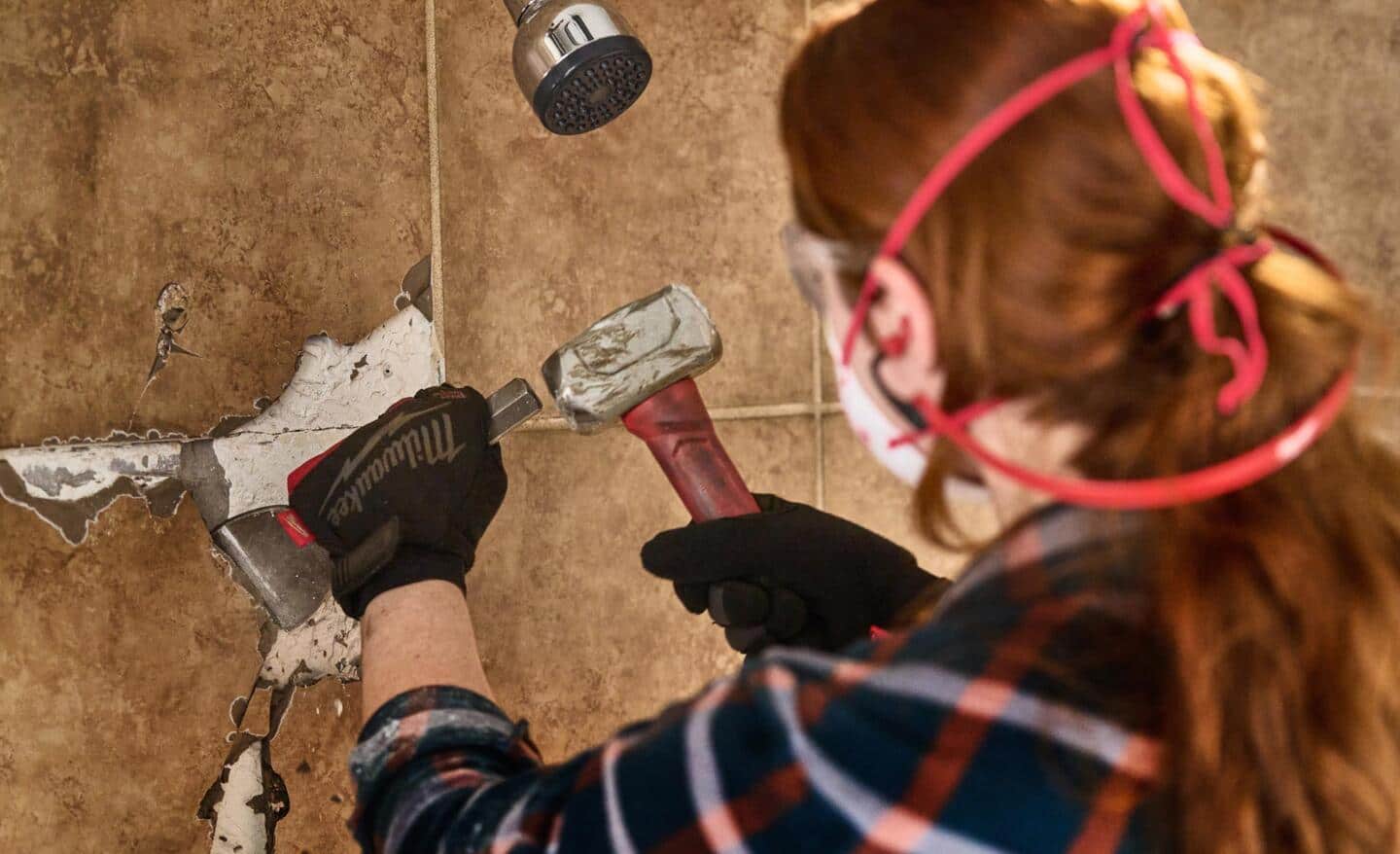 A Pro removes old bathroom tile.