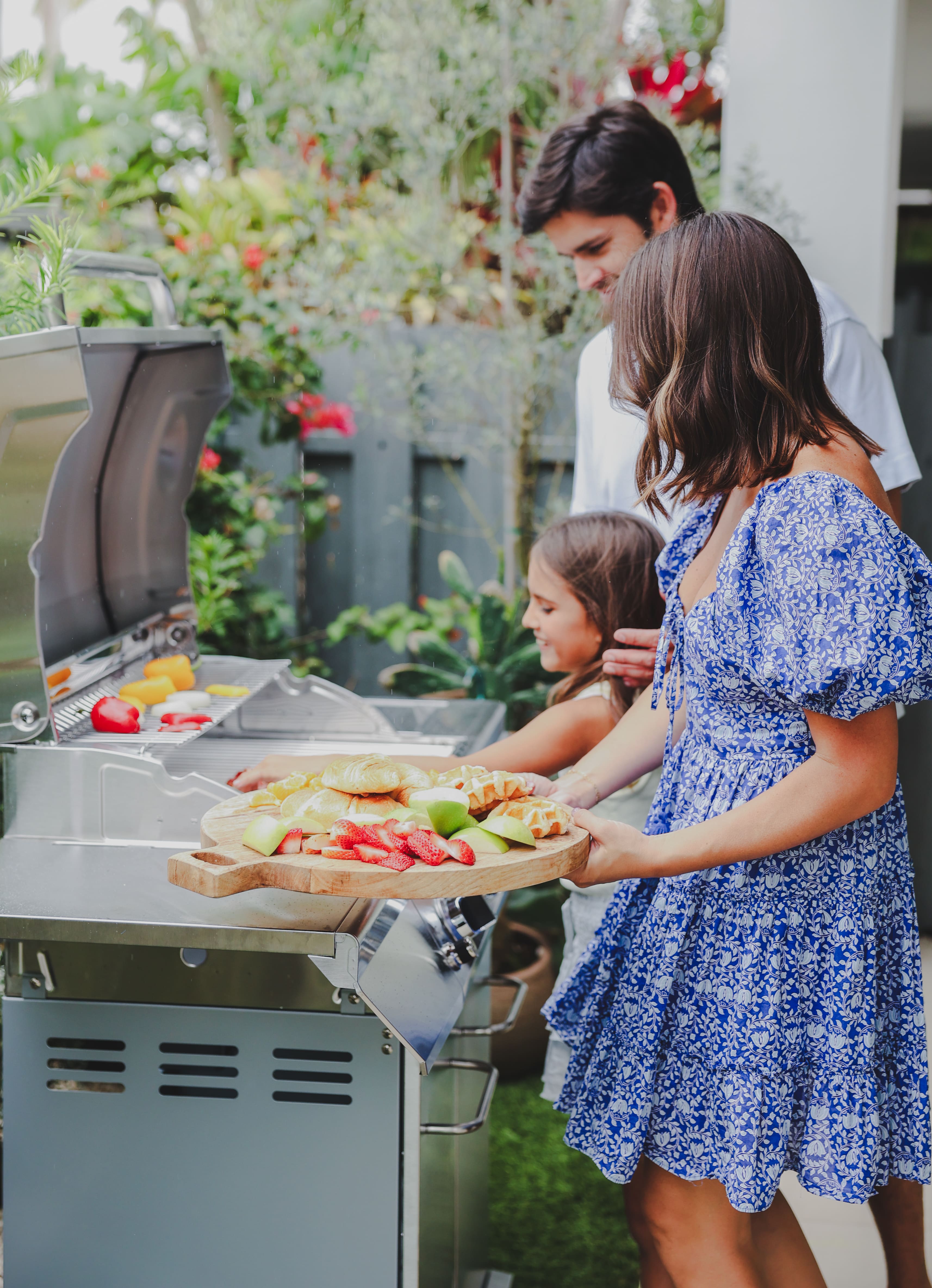 A family checking out their new grill