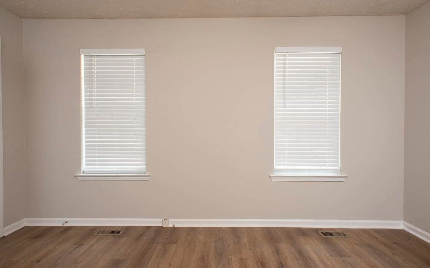 A wall with two windows.