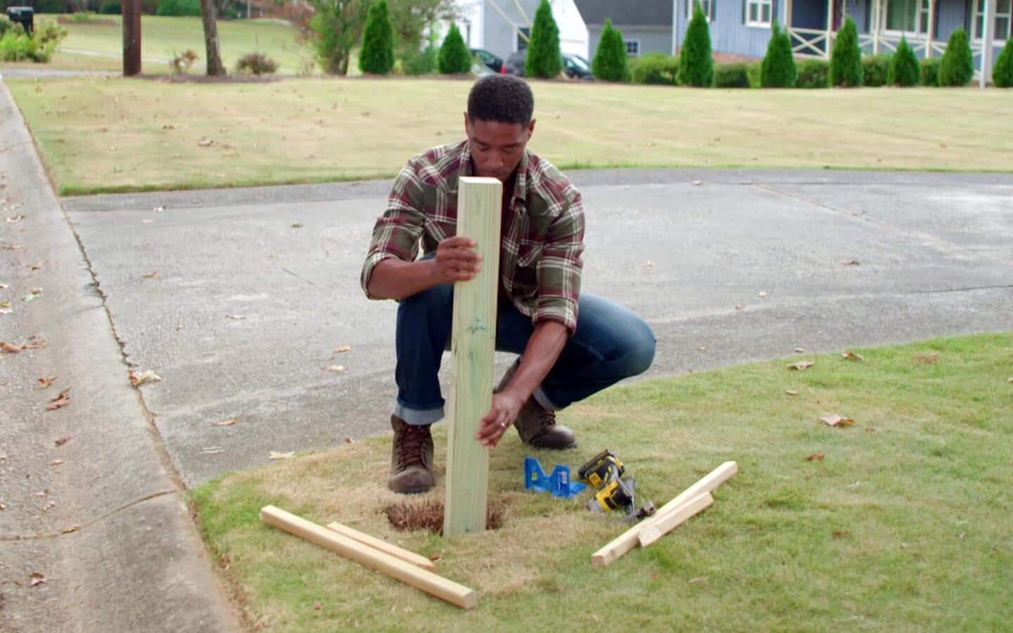 Someone installing a post for a mailbox. Someone installing a post for a mailbox.