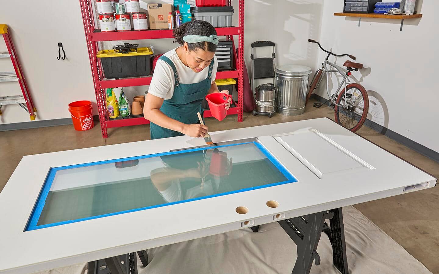 A door has been placed on sawhorses and is being painted. A door has been placed on sawhorses and is being painted.