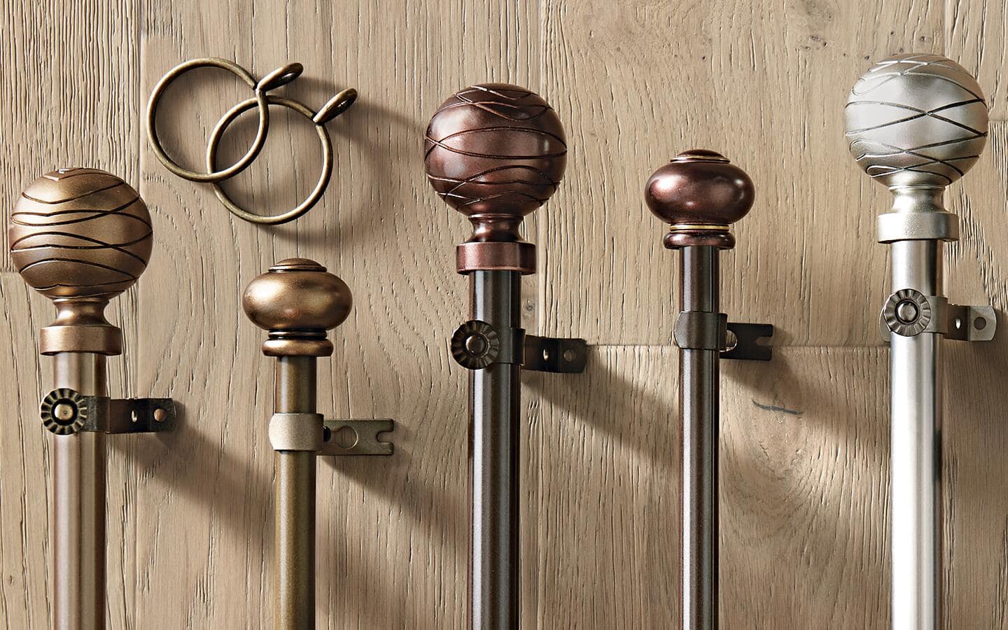 Multiple curtain rods, with different lengths and finishes, as well as finials.  Multiple curtain rods, with different lengths and finishes, as well as finials.