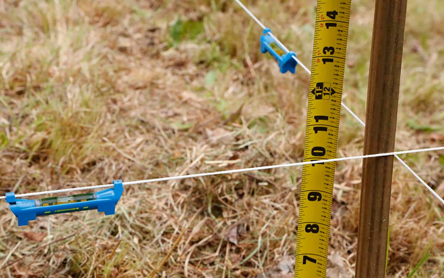 Line levels on strings set up in a field to mark levels. Line levels on strings set up in a field to mark levels.