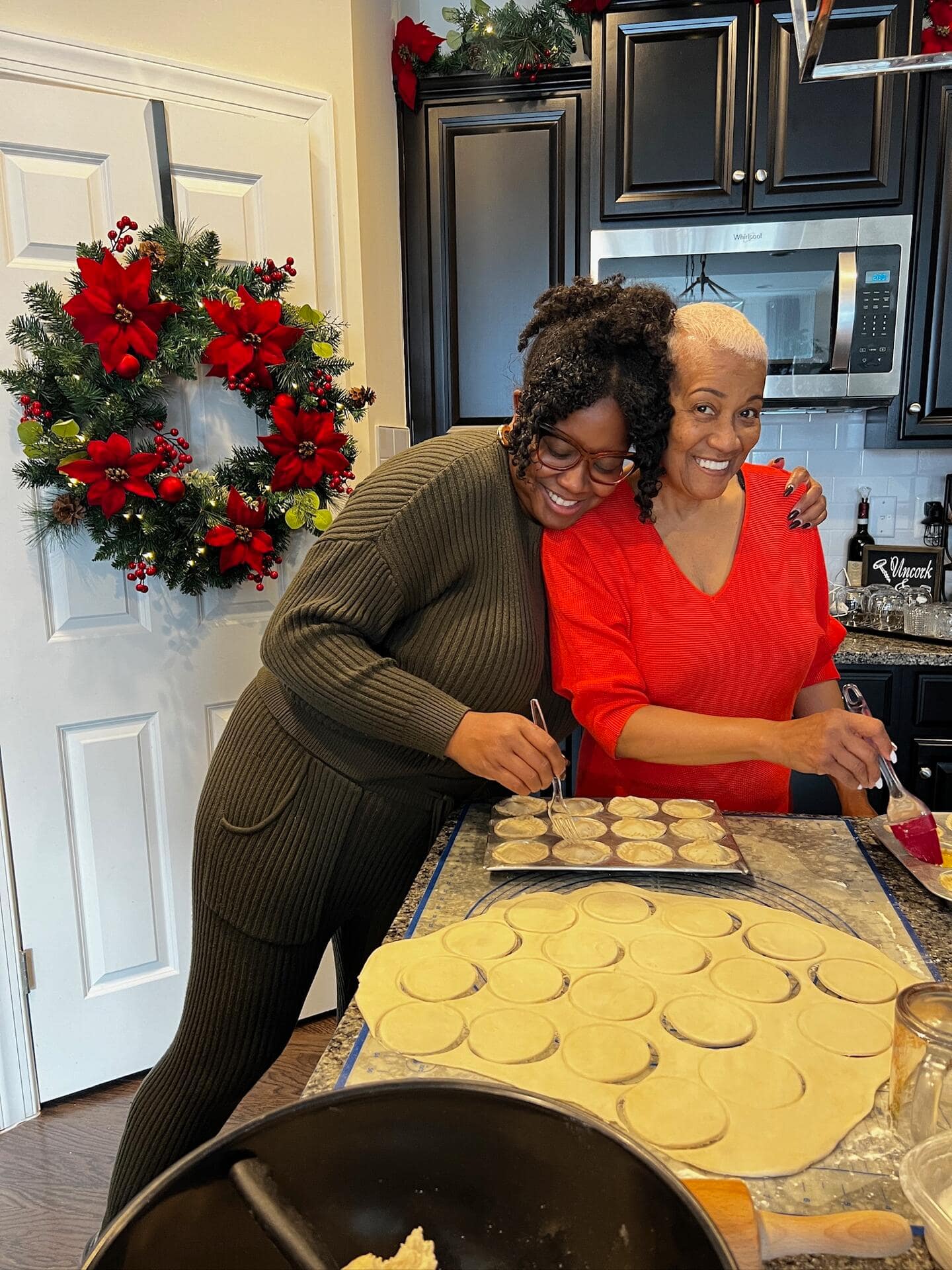 Two people baking in the decorated kitchen space.
