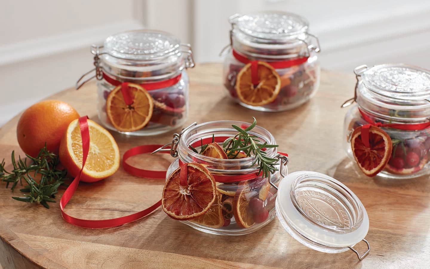 Dried orange slices in glass jars with red bows make great holiday garden gifts. Dried orange slices in glass jars with red bows make great holiday garden gifts.