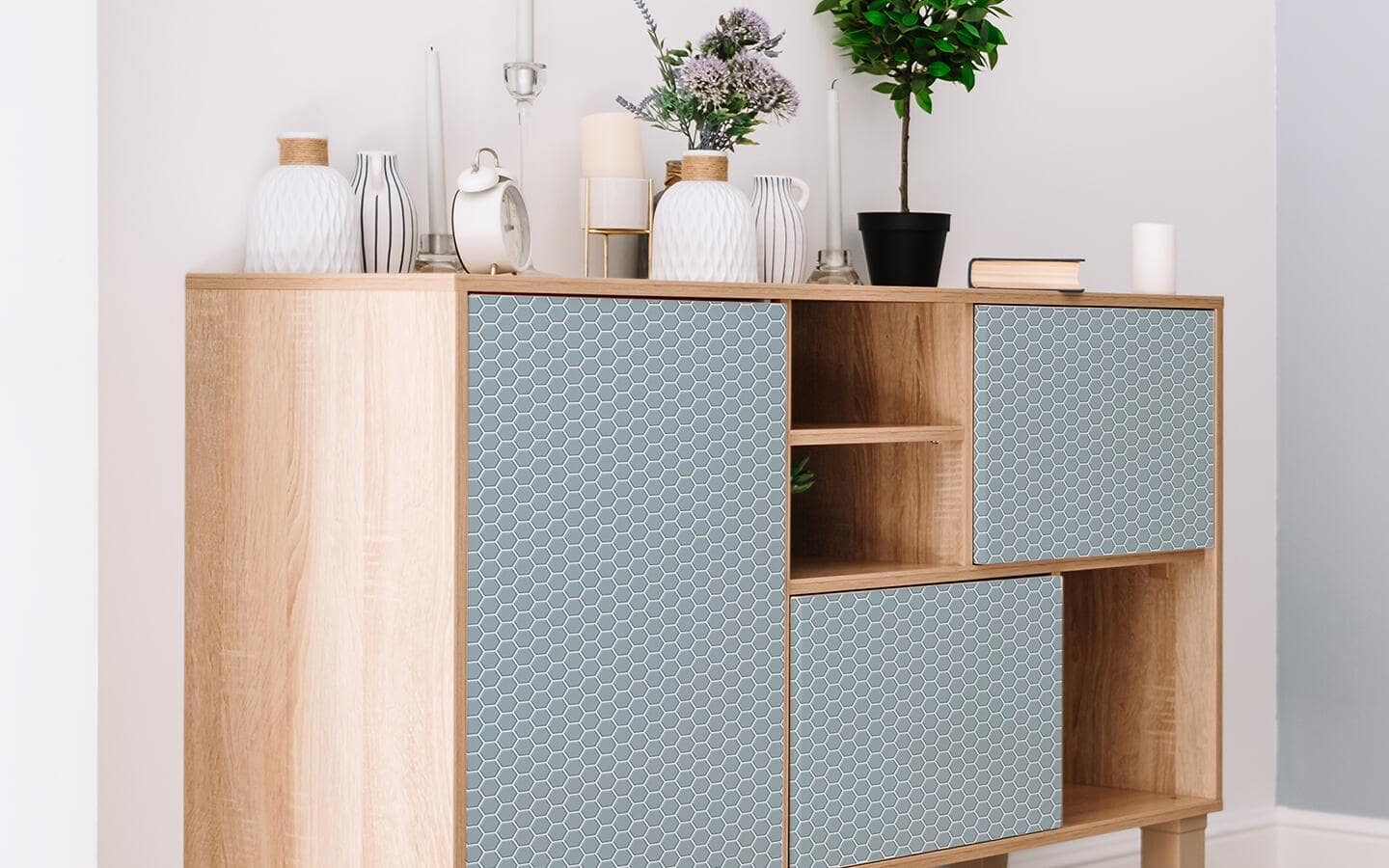 Peel and stick wallpaper decorates the front of a sideboard. Peel and stick wallpaper decorates the front of a sideboard.