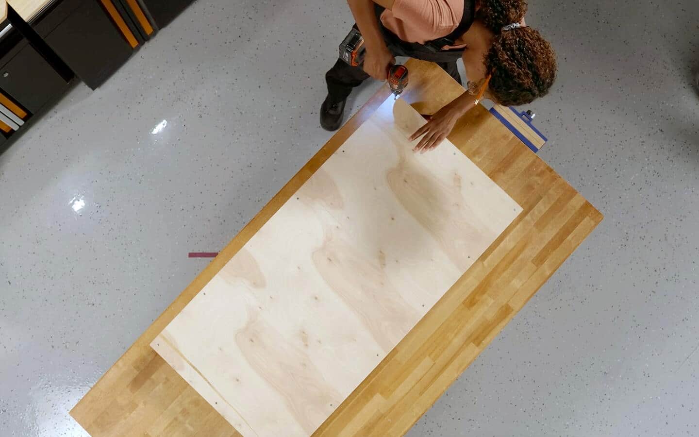 Someone working with two pieces of plywood. Someone working with two pieces of plywood.
