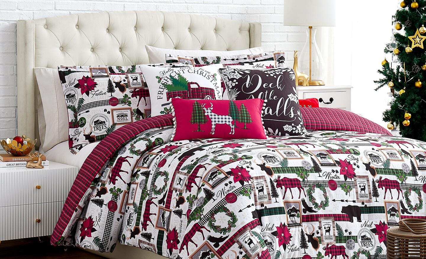 A bed covered in Christmas bedding. A bed covered in Christmas bedding.
