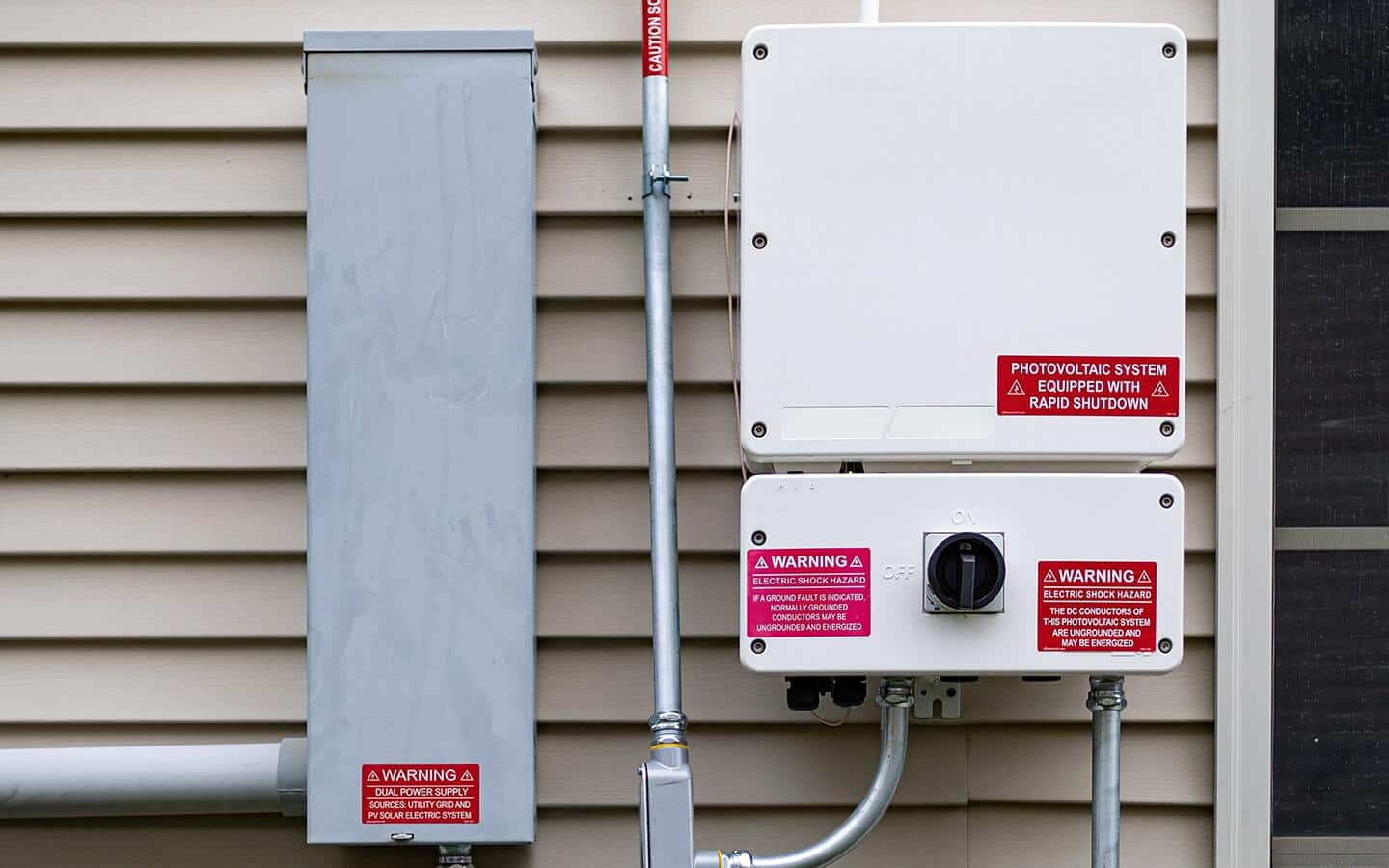 An outdoor electrical service box with an “Emergency Disconnect” label. An outdoor electrical service box with an “Emergency Disconnect” label.