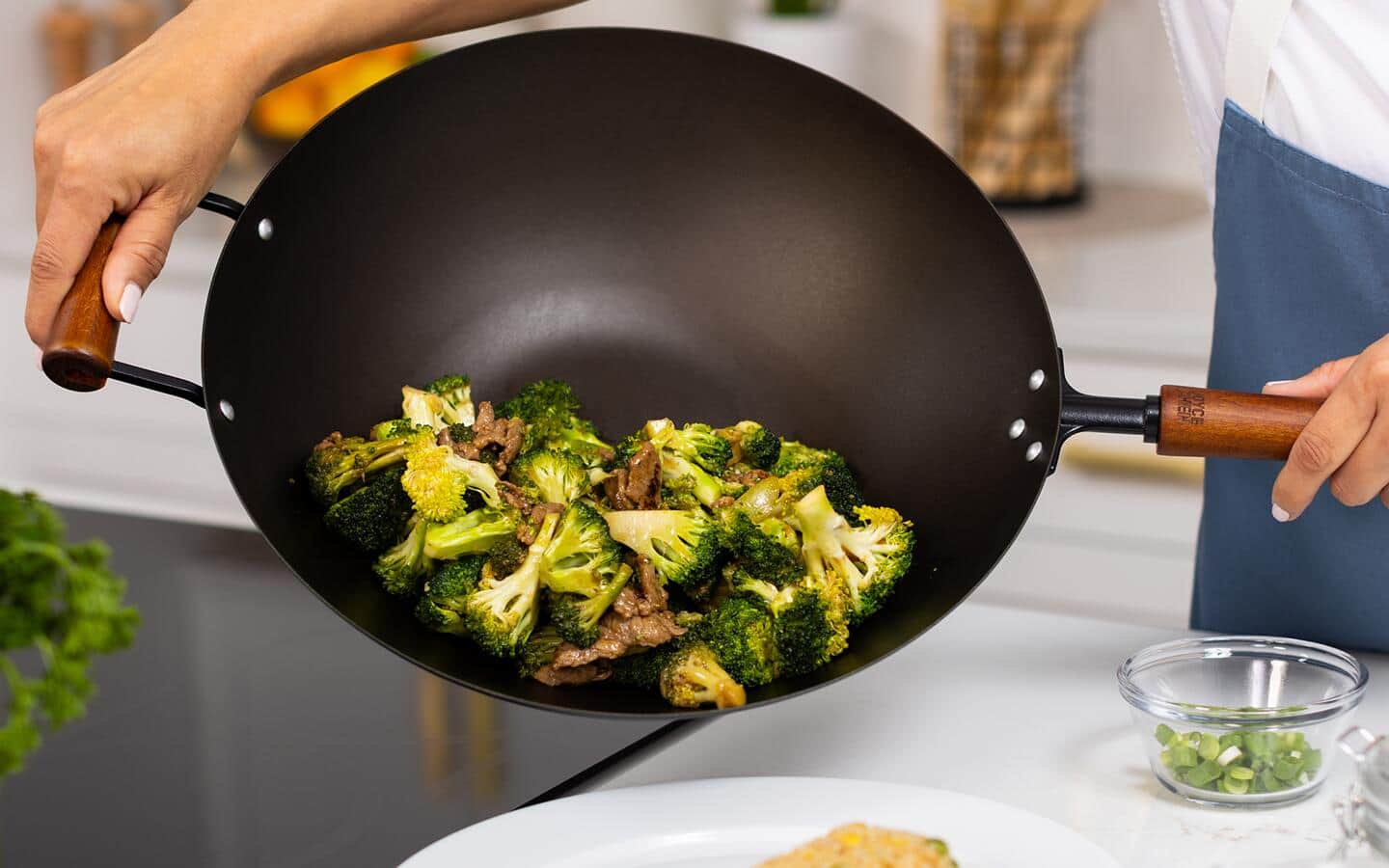 A meal being poured from a carbon steel wok. A meal being poured from a carbon steel wok.