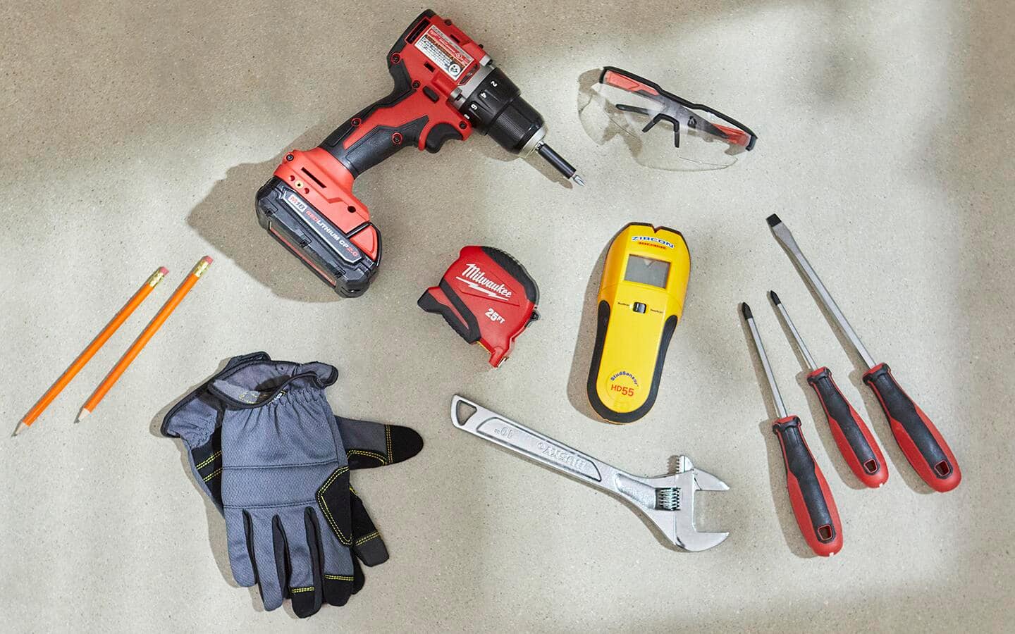 Tools for installing a smart garage door opener including a cordless drill, wrench, screwdrivers and eye protection are displayed