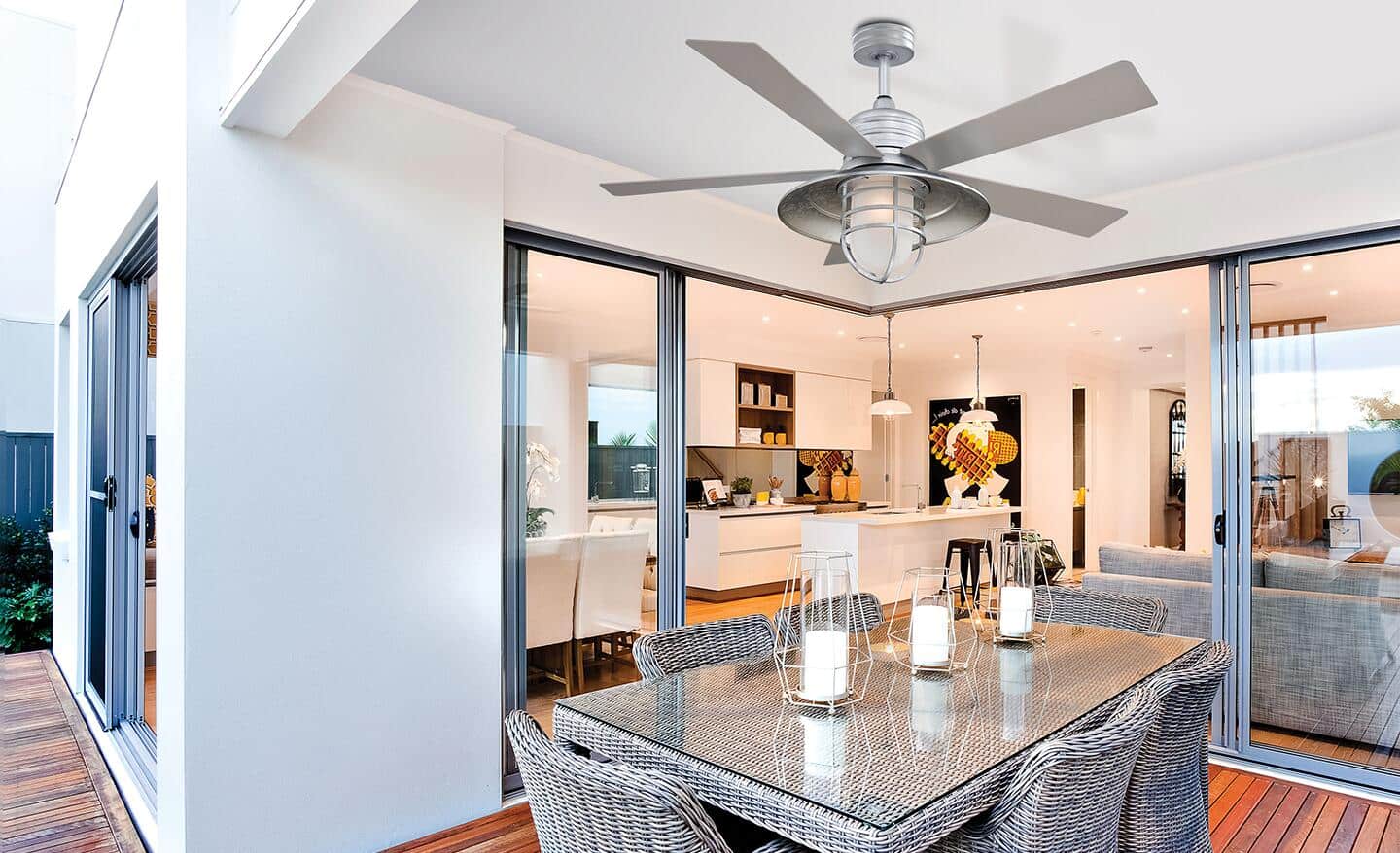 A large ceiling fan installed over a formal dining room.