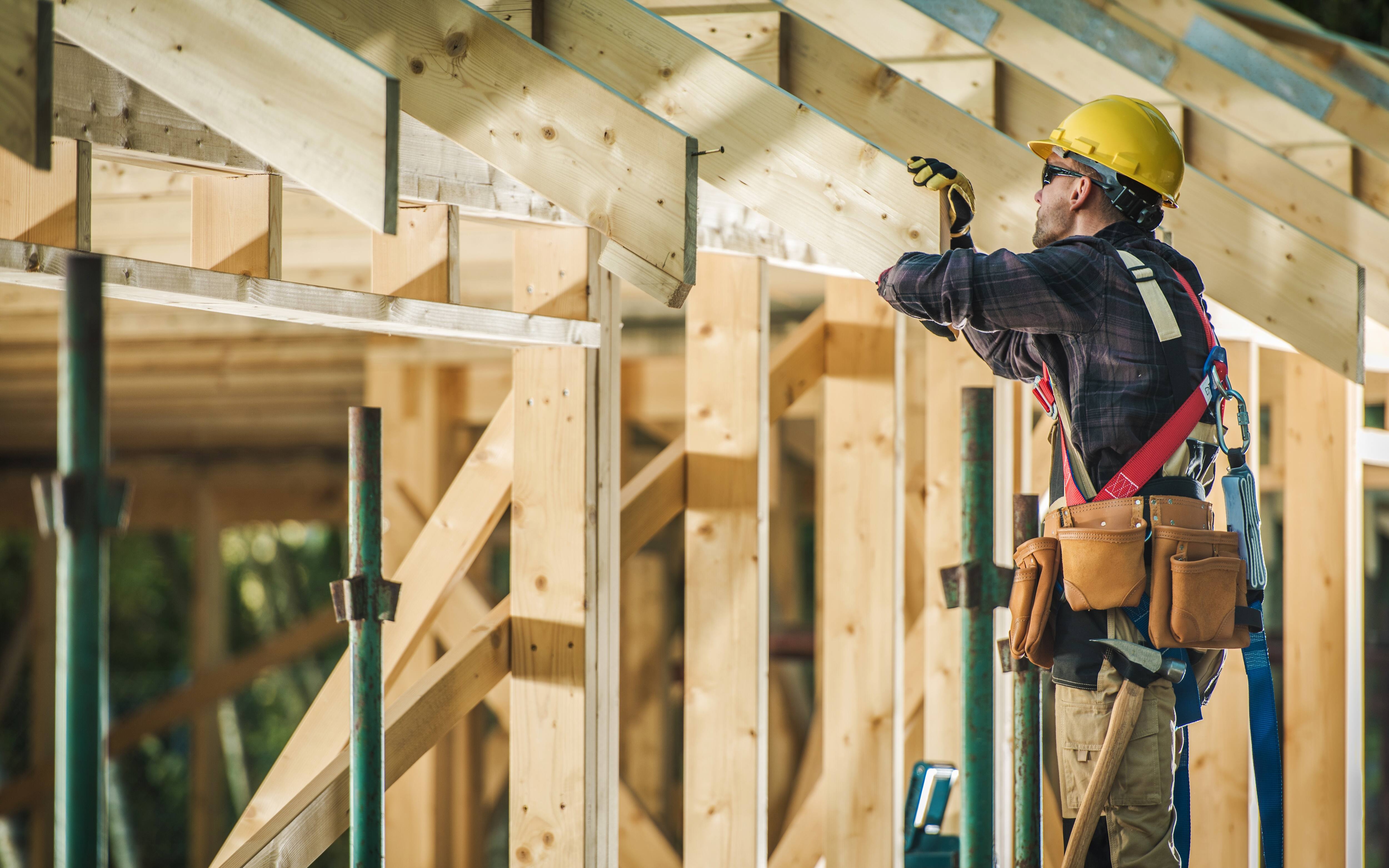 A Pro frames a roof.