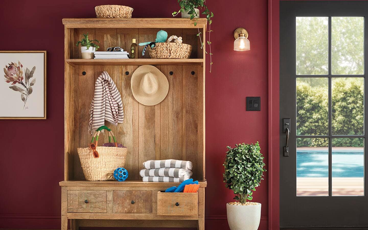 Complementary dark red and dark green colors give a mudroom an inviting look.