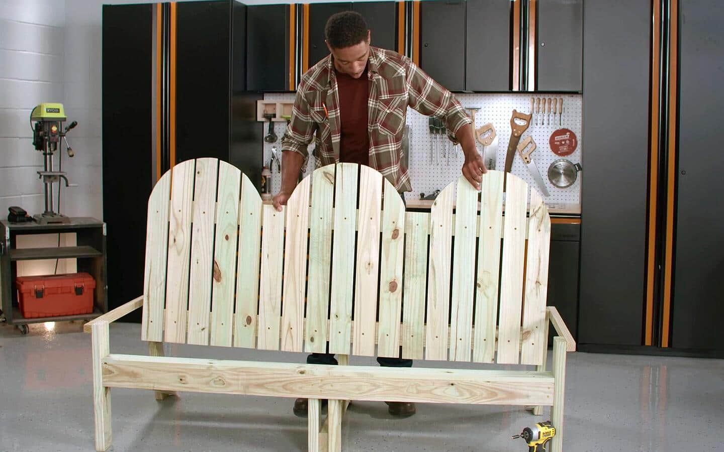 An individual assembles the seat back for an outdoor sofa in a workshop. An individual assembles the seat back for an outdoor sofa in a workshop.
