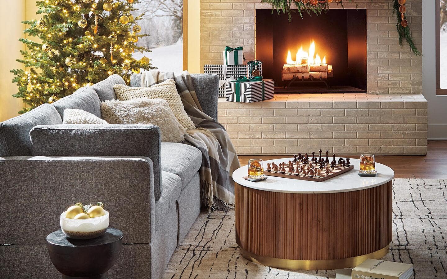 A modern living room featuring a Christmas tree and cozy fire. A modern living room featuring a Christmas tree and cozy fire.
