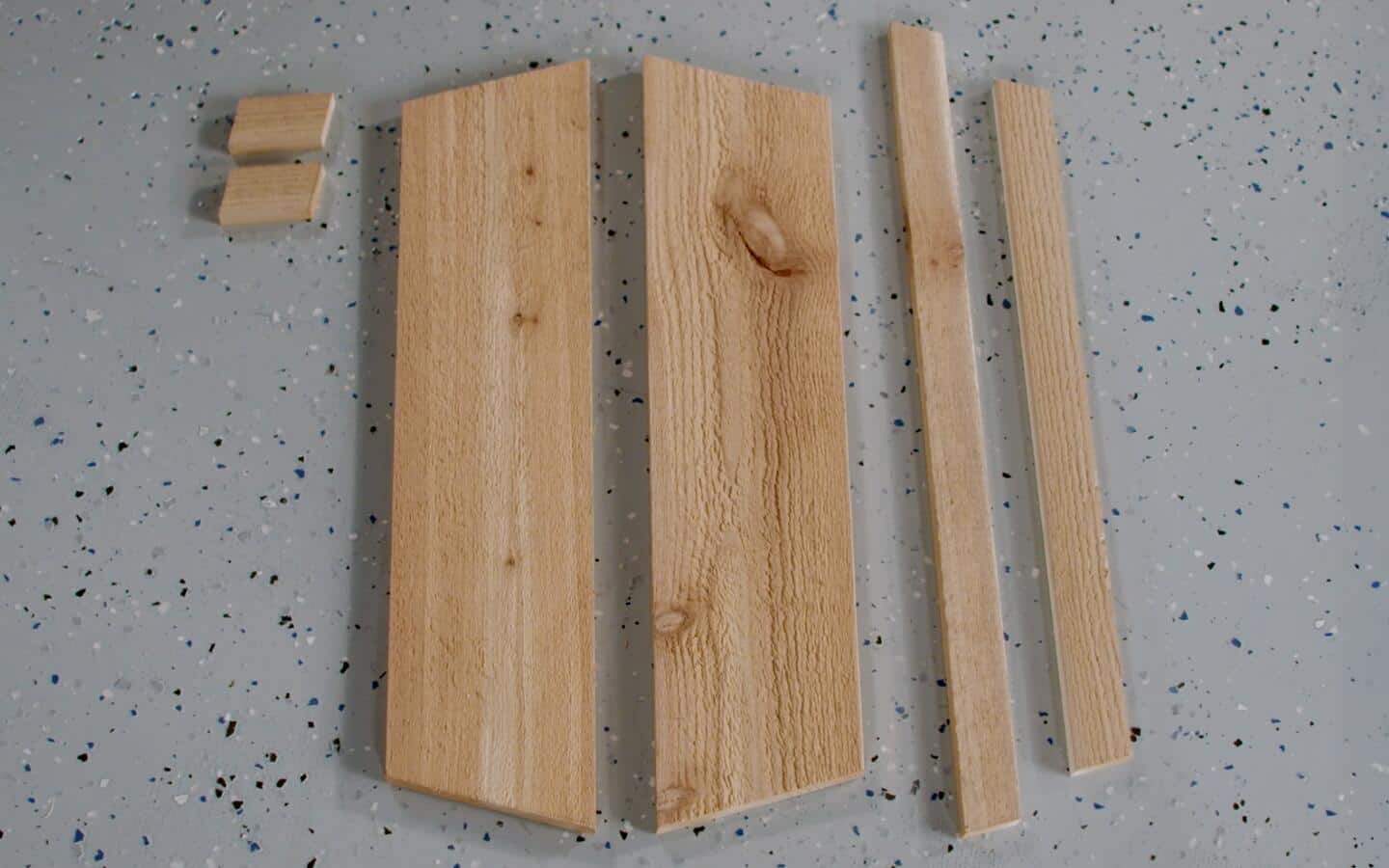 Various lengths and sizes of wood gathered to build a window box.