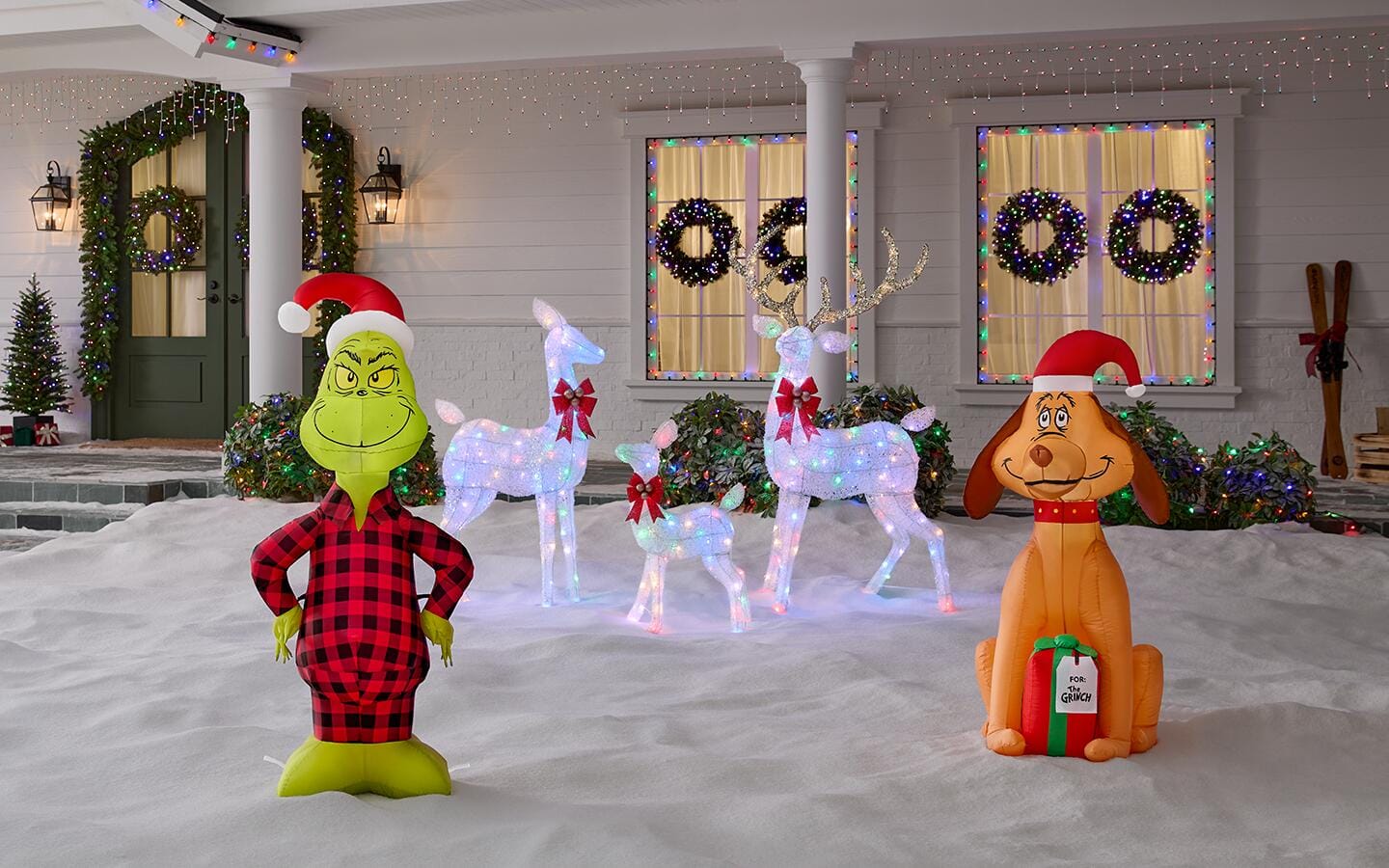 Holiday inflatables in a snowy front yard Holiday inflatables in a snowy front yard