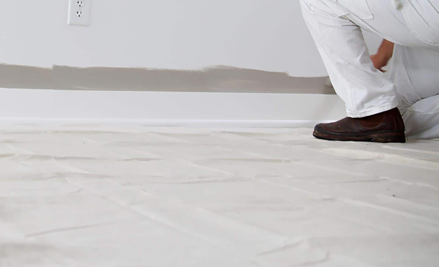  A canvas drop cloth on the floor of a room being painted.