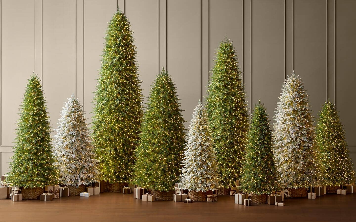 Various artificial trees of different heights and widths displayed in a room.