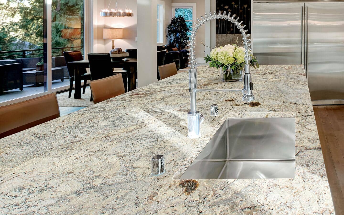 A granite kitchen countertop with brown and gray veining on a kitchen island