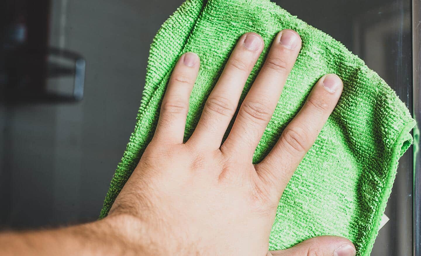 Cleaning glass with a microfiber towel.