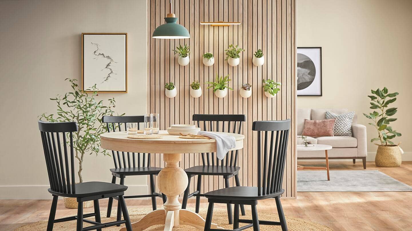 A dining room with a wood room divider.