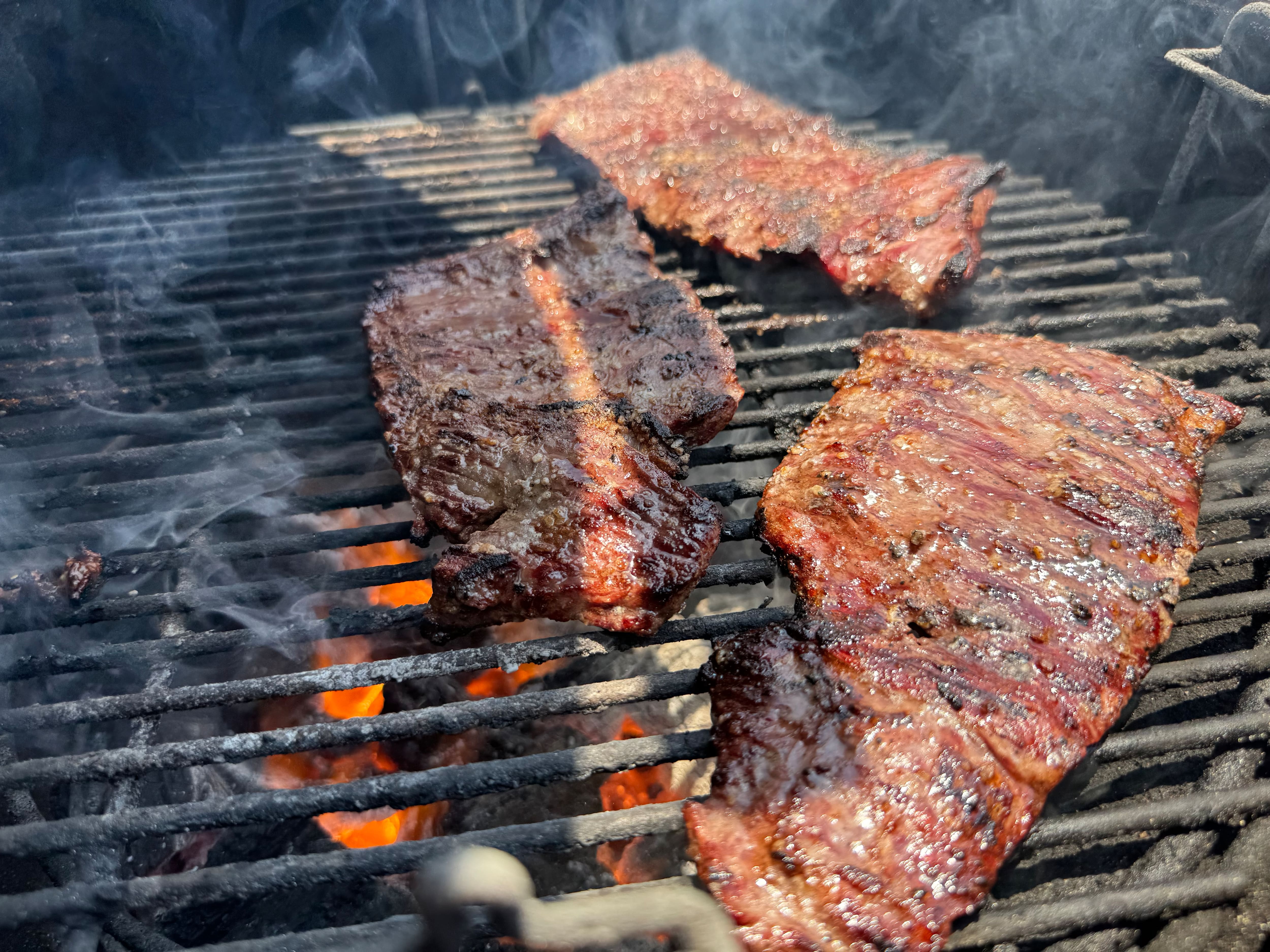 Steak cooking over a grill. Steak cooking over a grill.