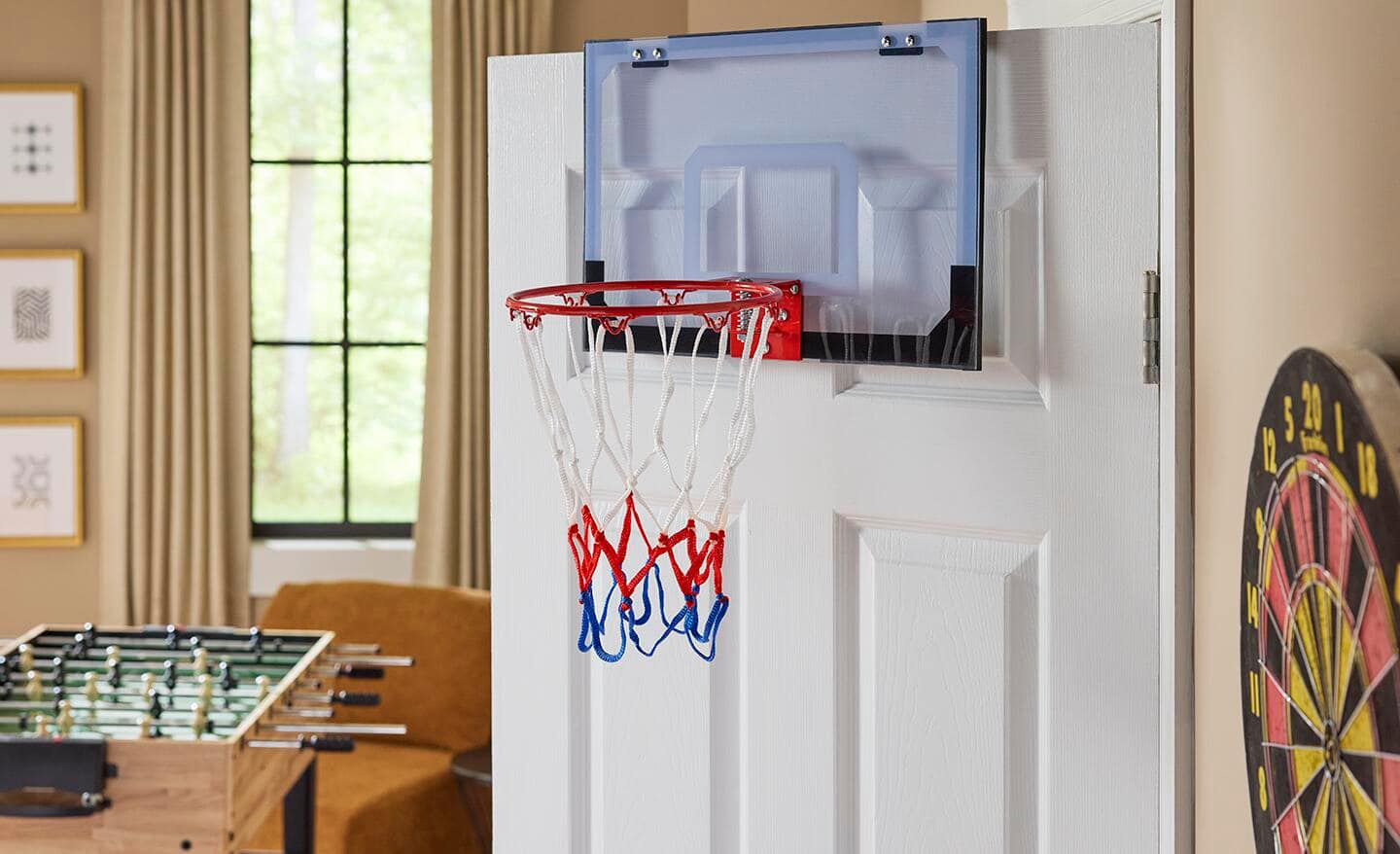 A red, white and blue basketball hoop hanging over the back of a door. A red, white and blue basketball hoop hanging over the back of a door.
