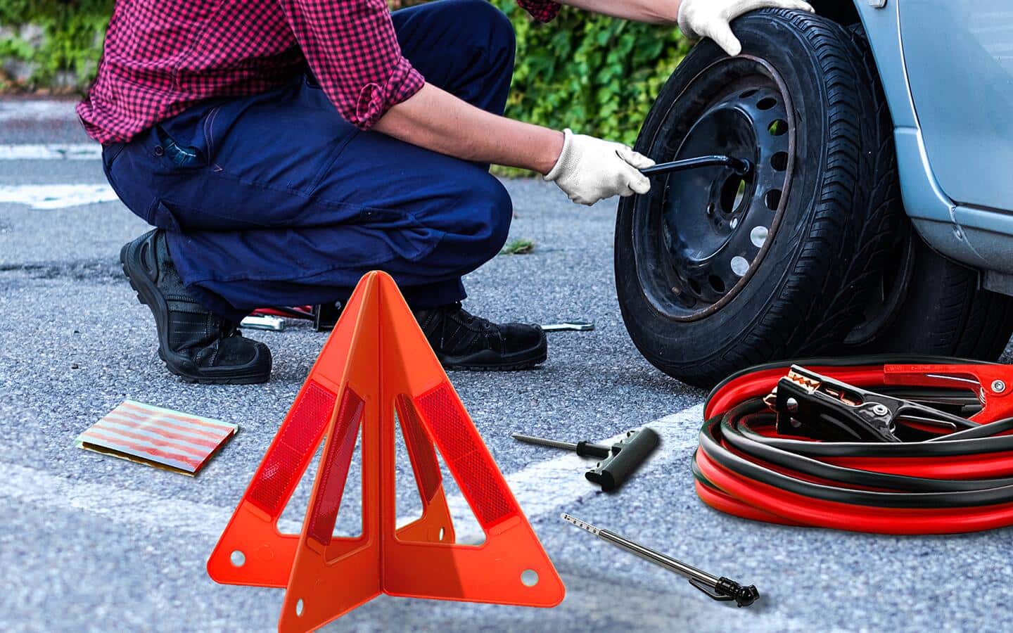 A roadside car emergency kit beside a car. A roadside car emergency kit beside a car.