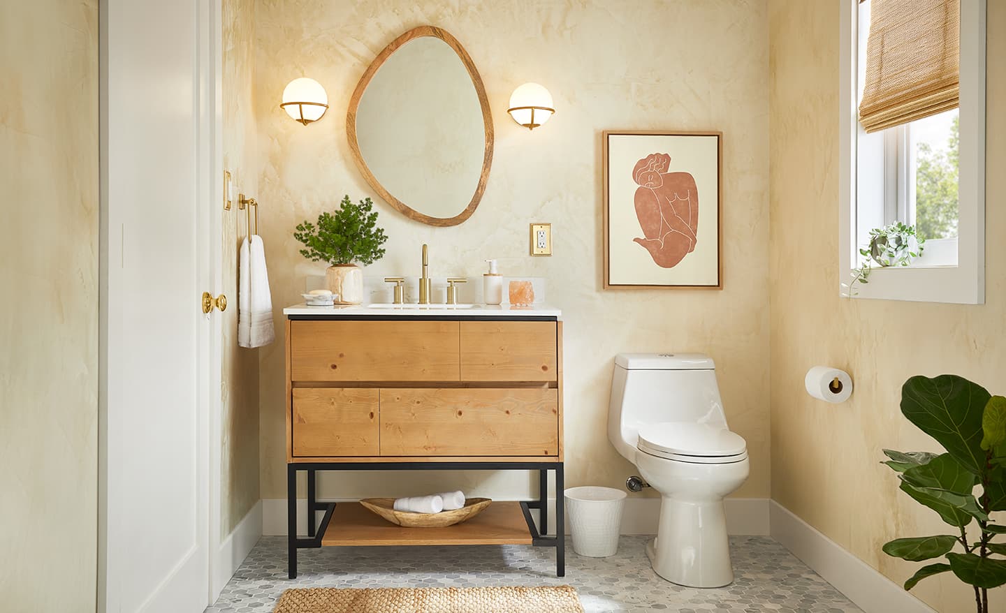 A modern vanity with a marble top and open storage.