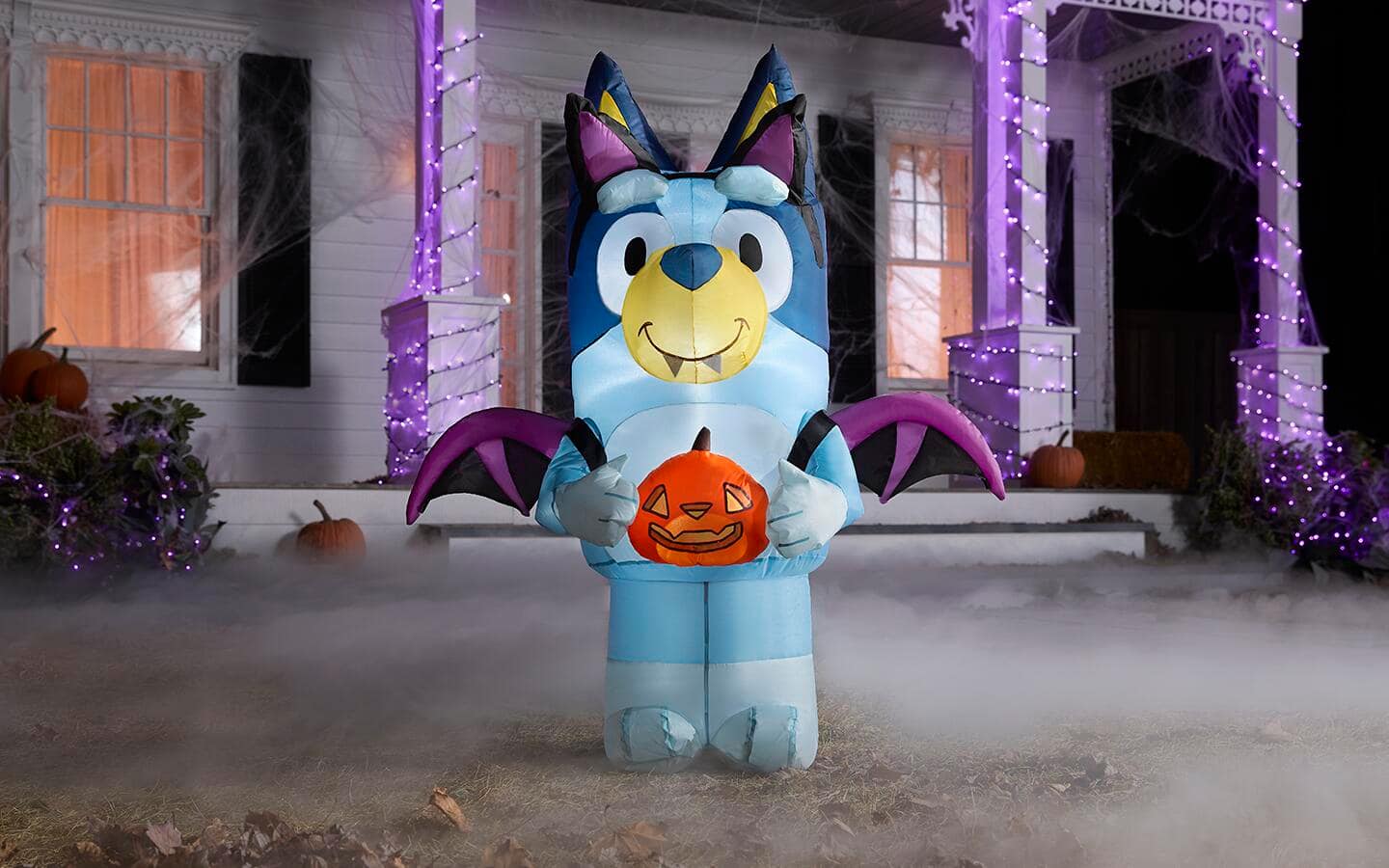 An inflatable Halloween Bluey figure sits in front of a Halloween porch. An inflatable Halloween Bluey figure sits in front of a Halloween porch.