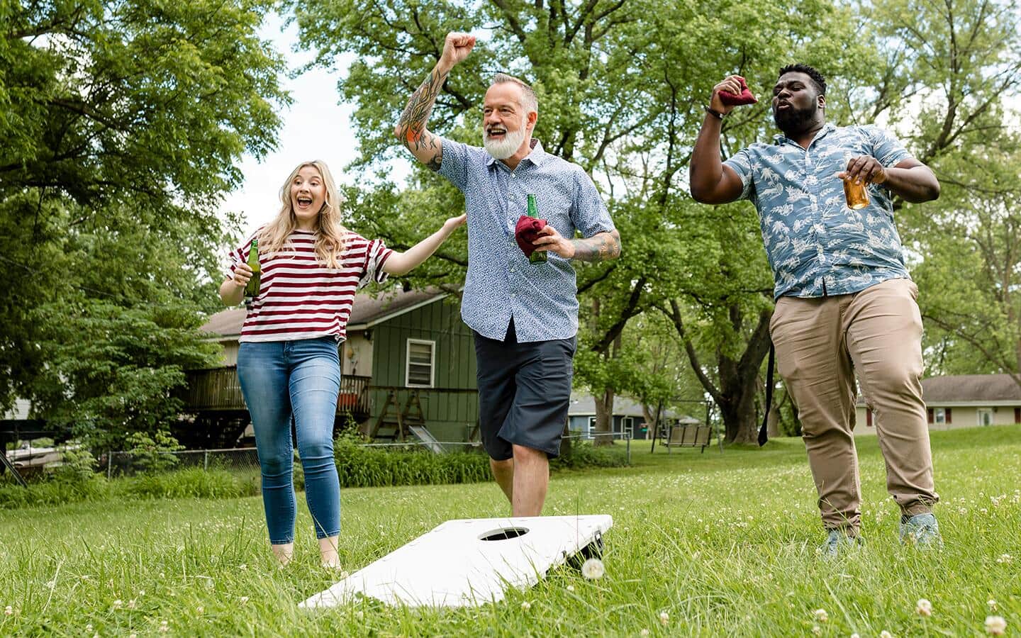 Friends playing cornhole together. Friends playing cornhole together.