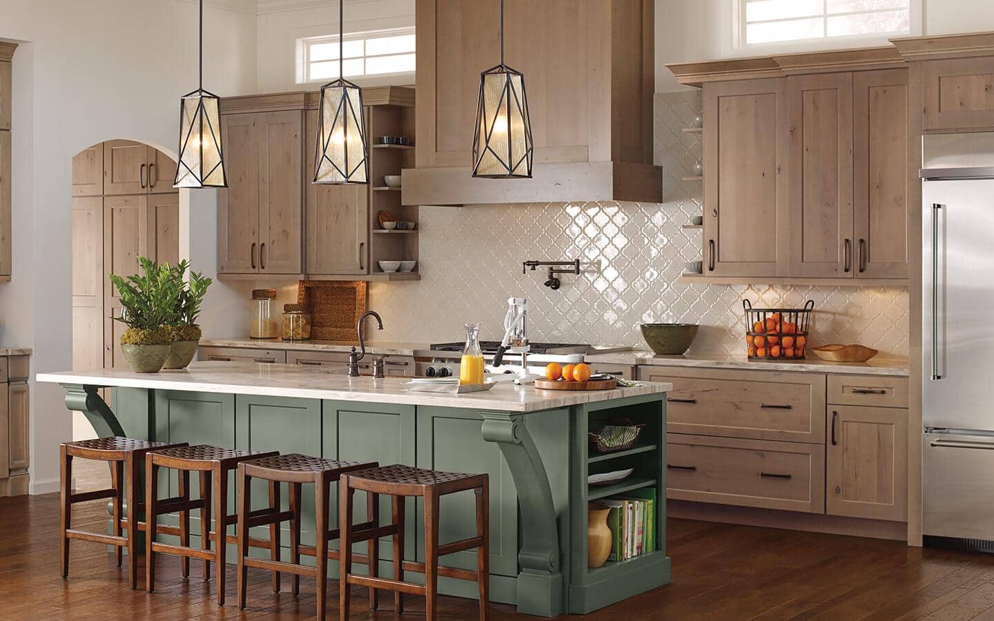 A kitchen featuring a green center island and light brown custom cabinets. A kitchen featuring a green center island and light brown custom cabinets.