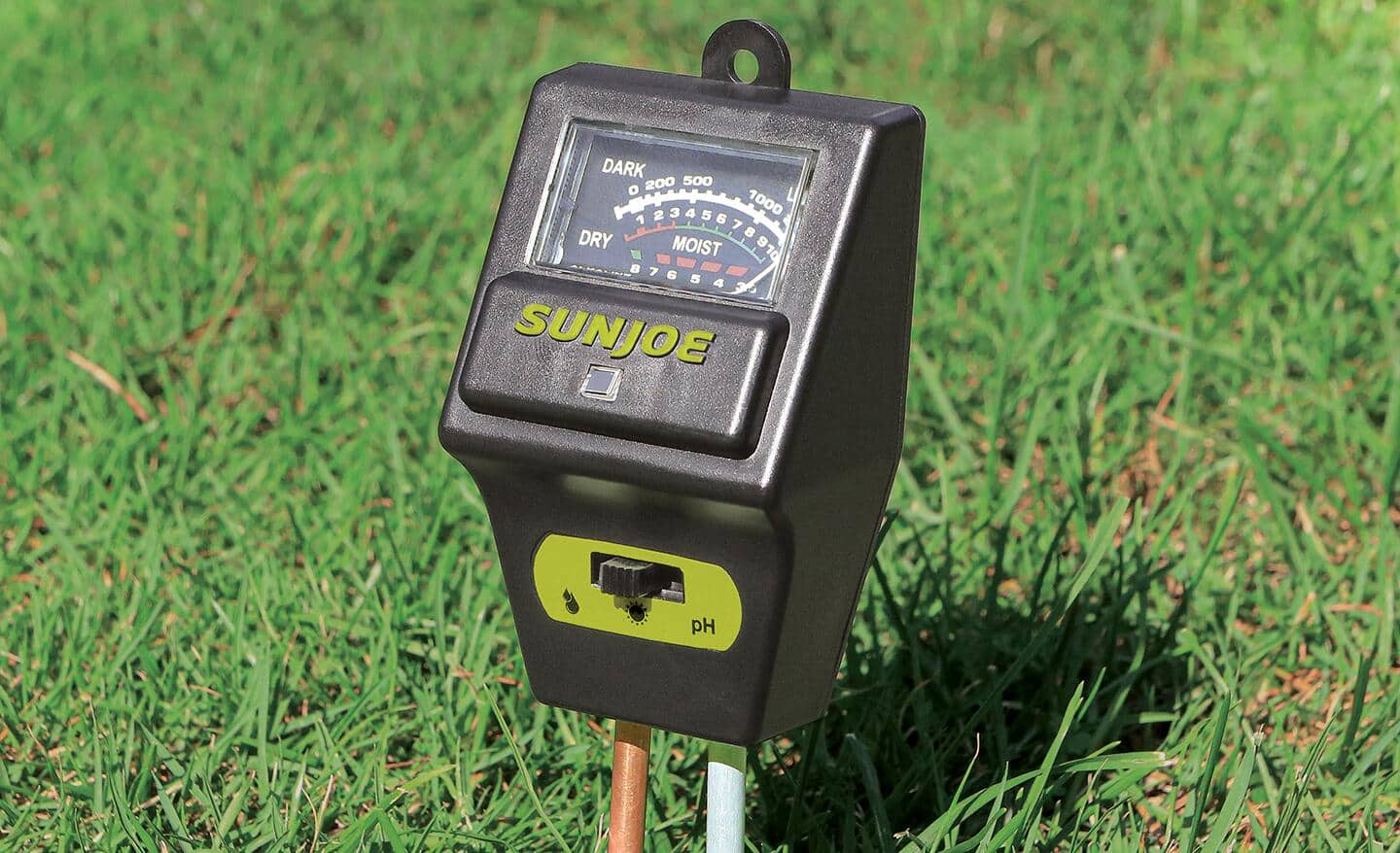 A pH tester inserted in soil