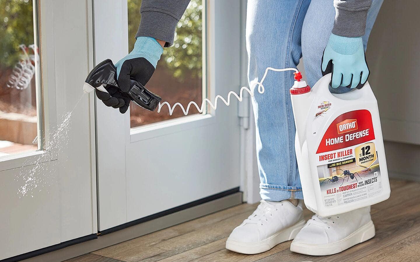 Someone wearing disposable gloves while spraying pesticide. 