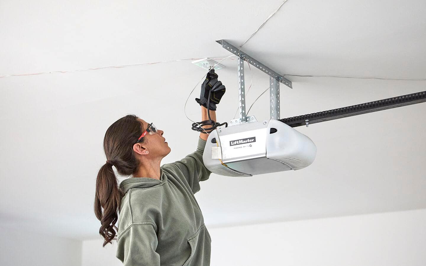 Person hangs the power unit of a smart garage door opener