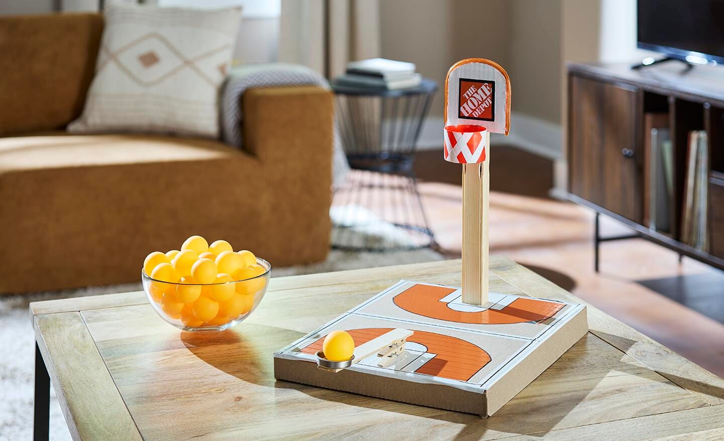 A DIY basketball game sitting on a coffee table. A DIY basketball game sitting on a coffee table.