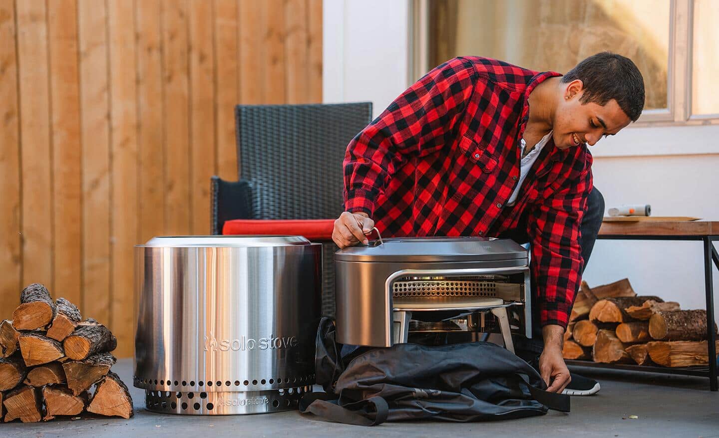 A person unwrapping a pizza oven.