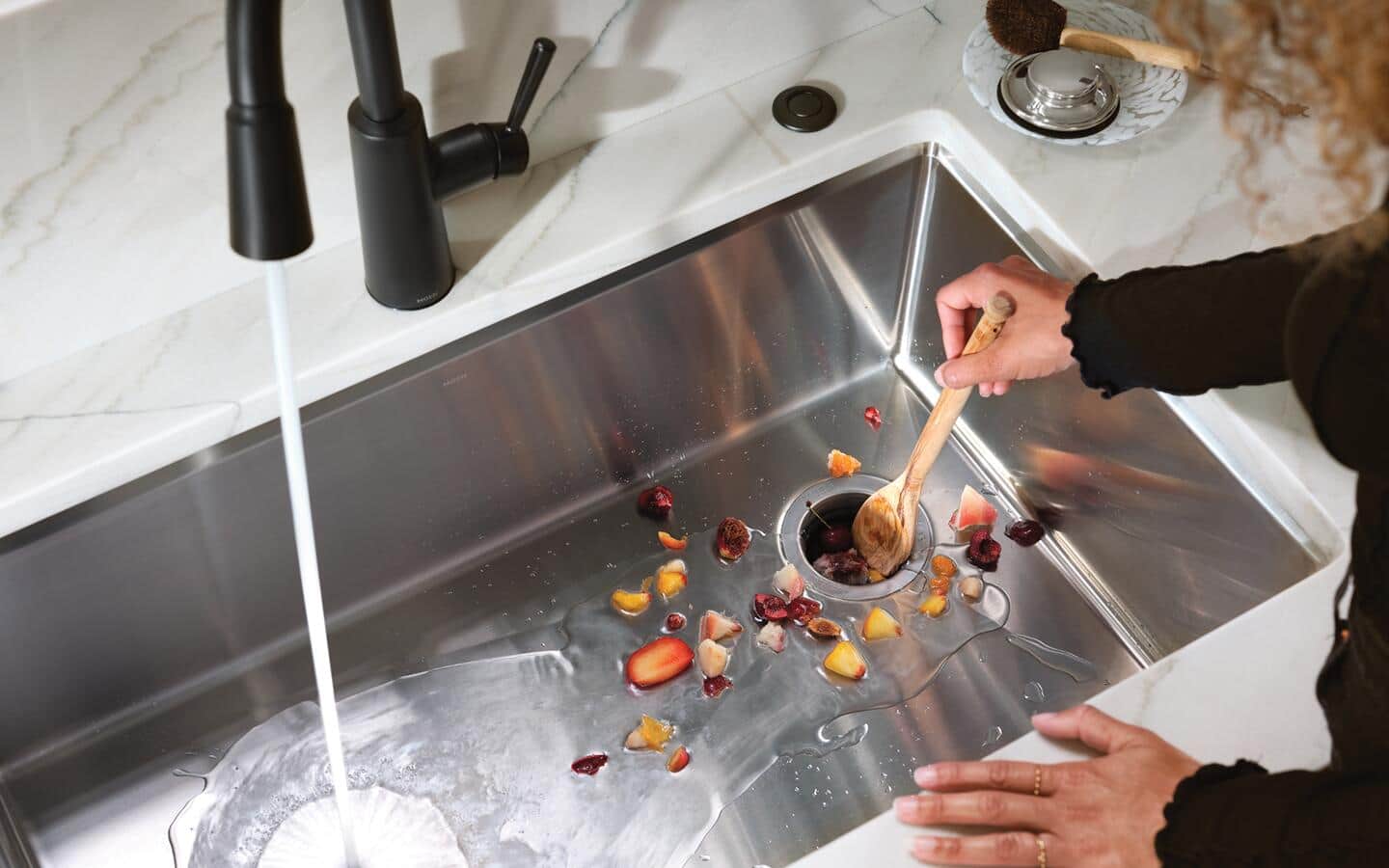 Someone using a new garbage disposal.