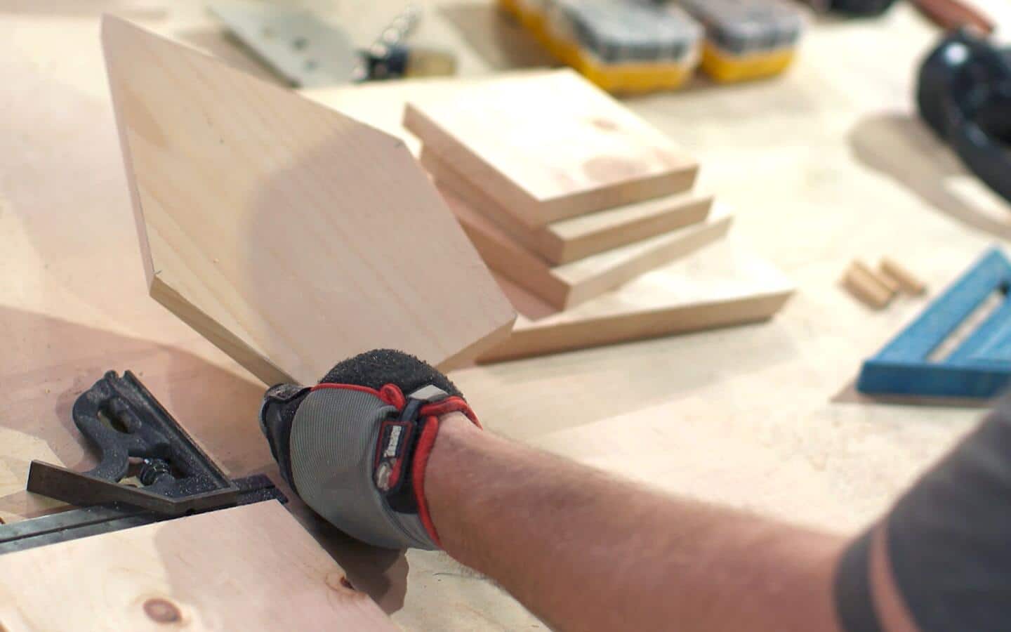 Wood being trimming for a birdhouse's front and back panels.