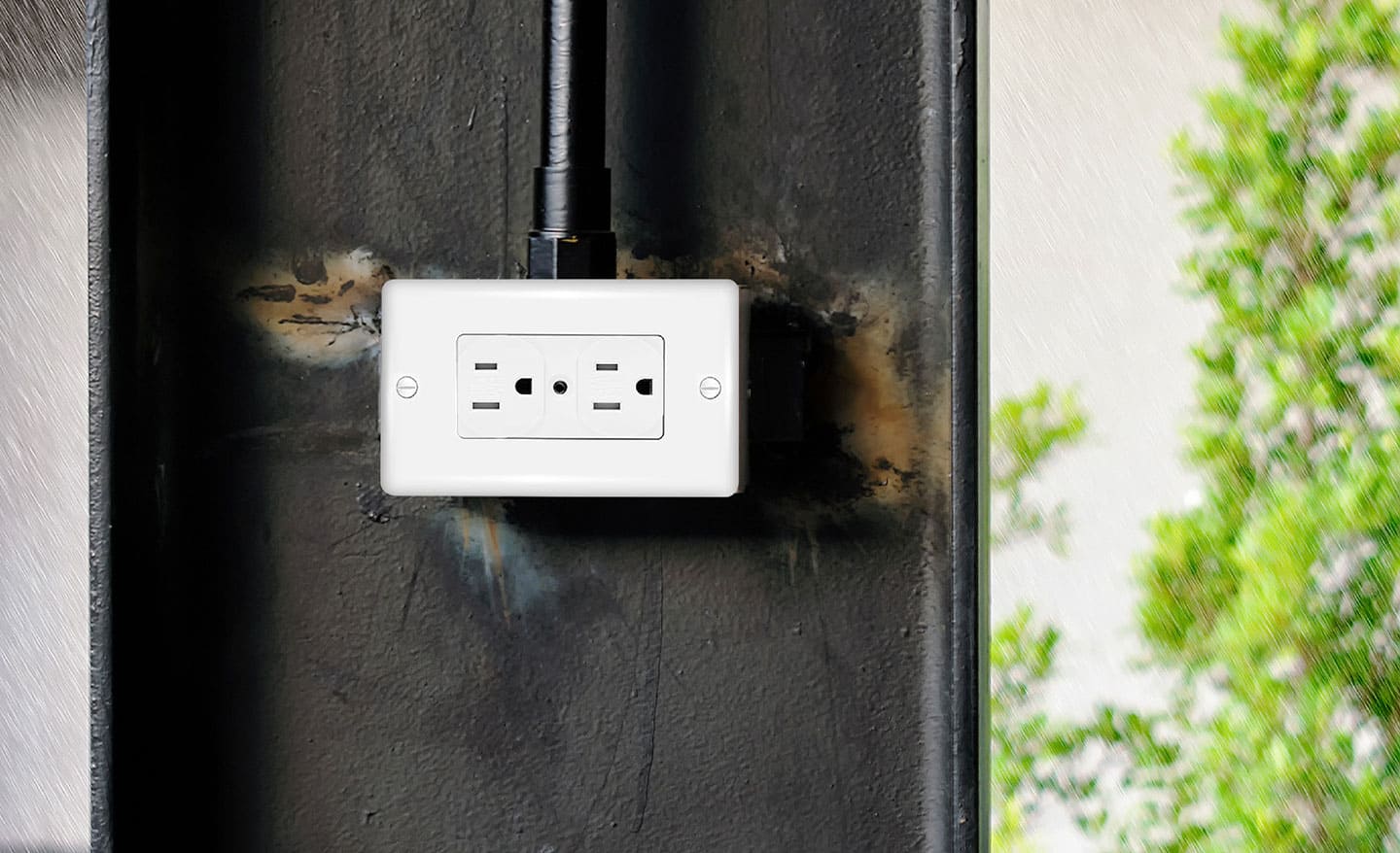 A weather-resistant receptacle installed on the outside of a home.
